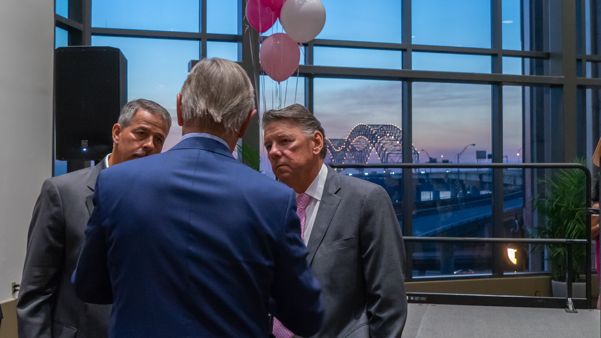 Men speak with Memphis bridge in the background