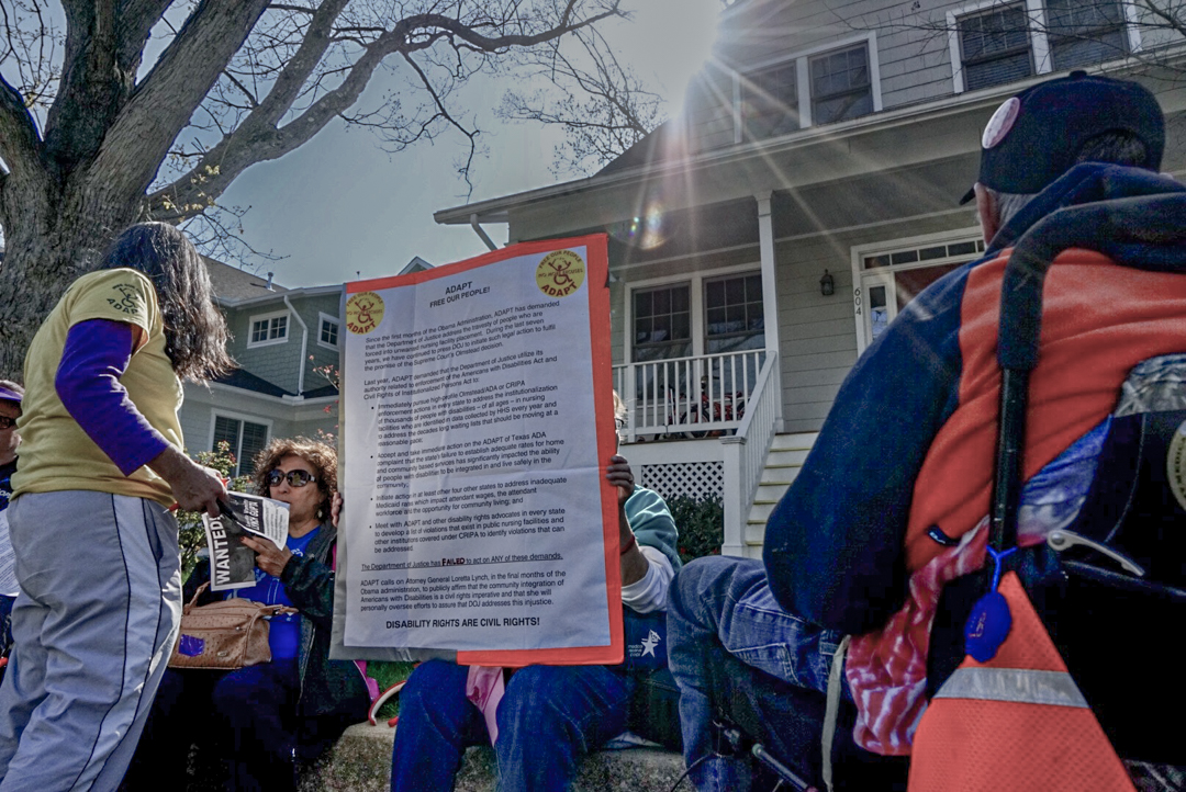 Activist's hold a sign that is unreadable