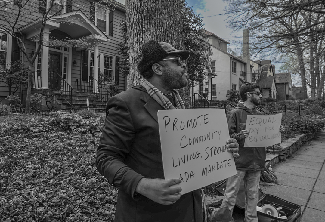 Activist's hold a sign that is readable but not informative
