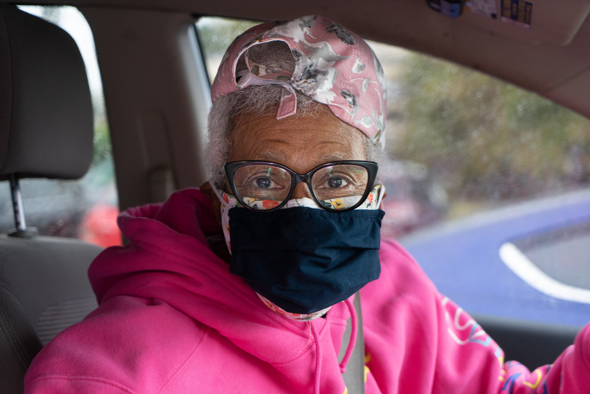  Woman wears pink with 2 masks 