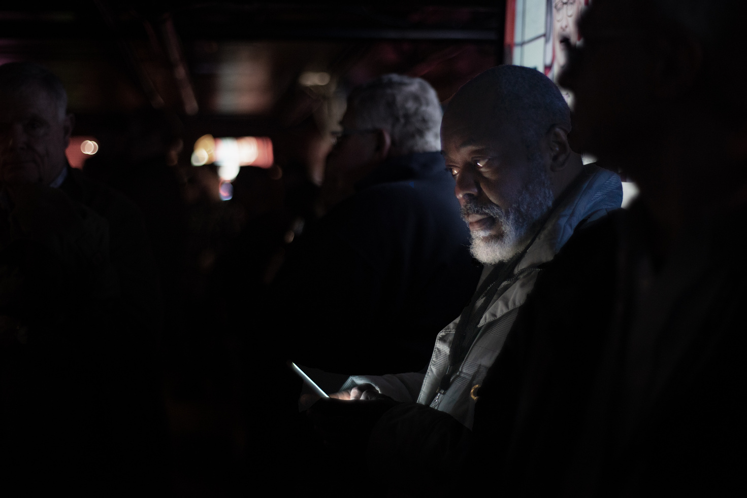  Man's face lit by his smartphone 